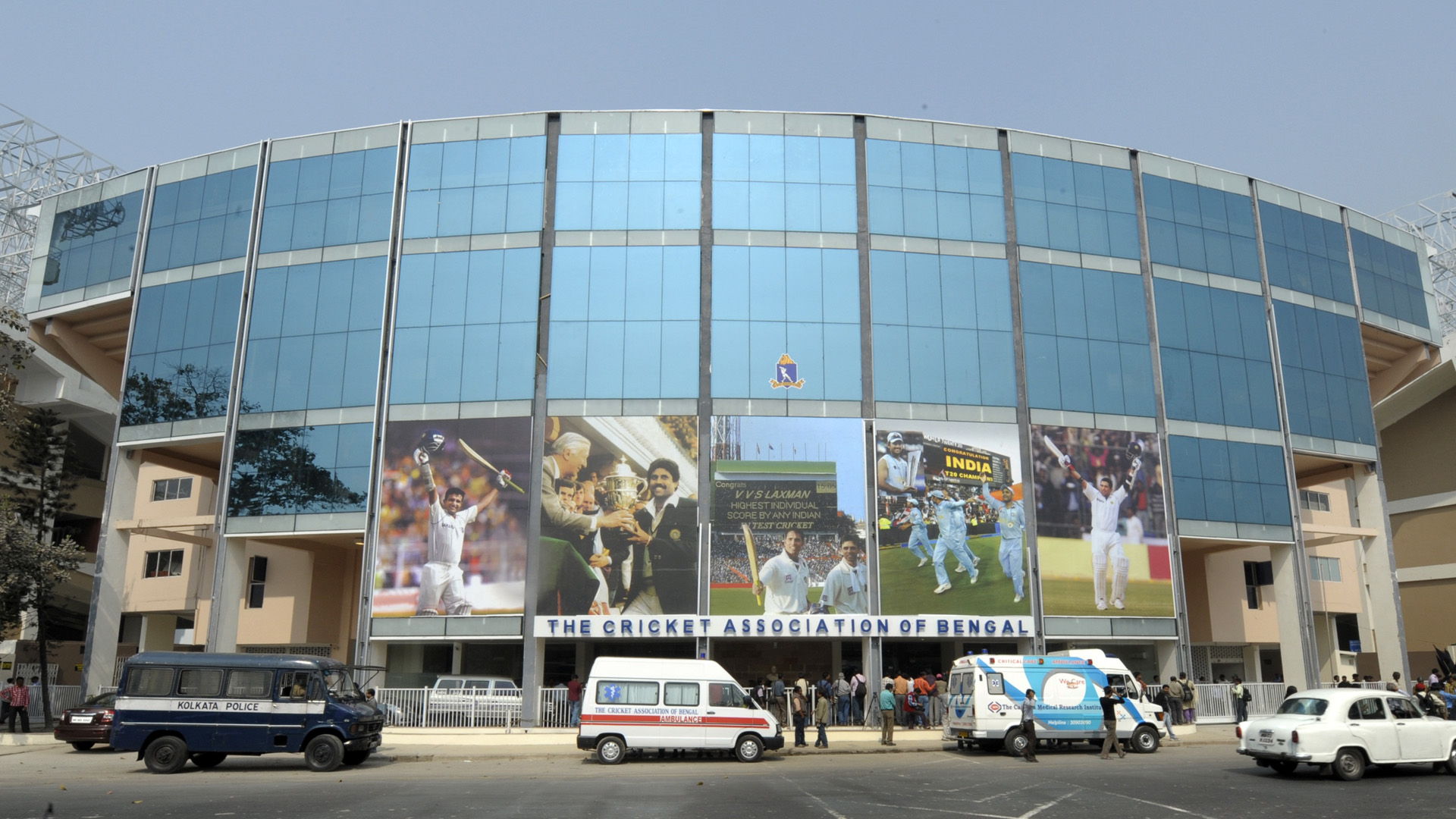 Journalists stand outside the Eden Gardens stadium in Kolkata, as International Cricket Council (ICC) observers visit the stadium on February 7, 2011. Three member ICC observer team visited the ground today to decide the possibility of hosing three other non-India World Cup matches in this venue. AFP PHOTO/Deshakalyan CHOWDHURY (Photo credit should read DESHAKALYAN CHOWDHURY/AFP/Getty Images)